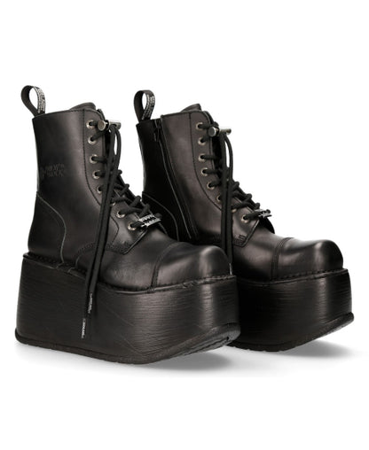 Pair of black platform boots on a white background