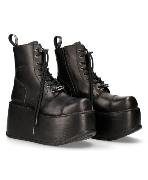 Pair of black platform boots on a white background