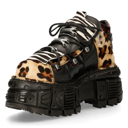 Pair of platform shoes with zebra and leopard print soles on a white background