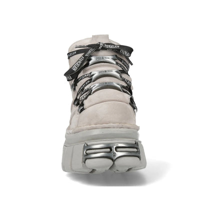 A light beige suede high-top sneaker with chunky silver metal eyelets and black laces printed with the brand name 'MCKELLARD'.