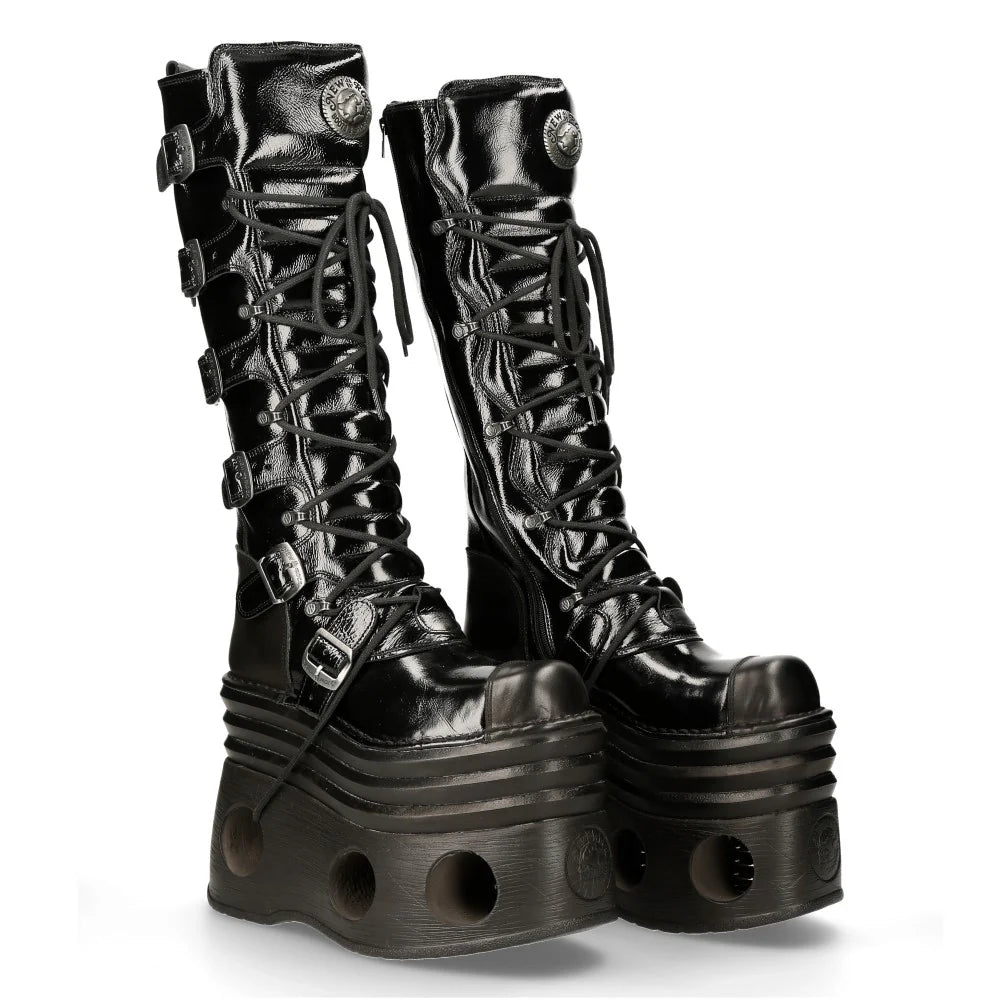 Black platform boots with detailed design on a white background