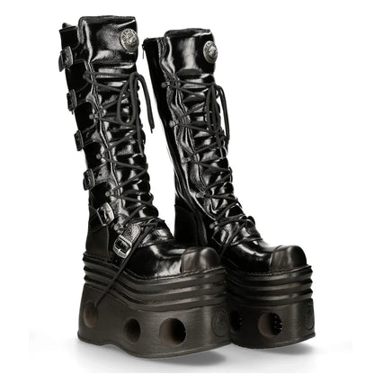 Black platform boots with detailed design on a white background