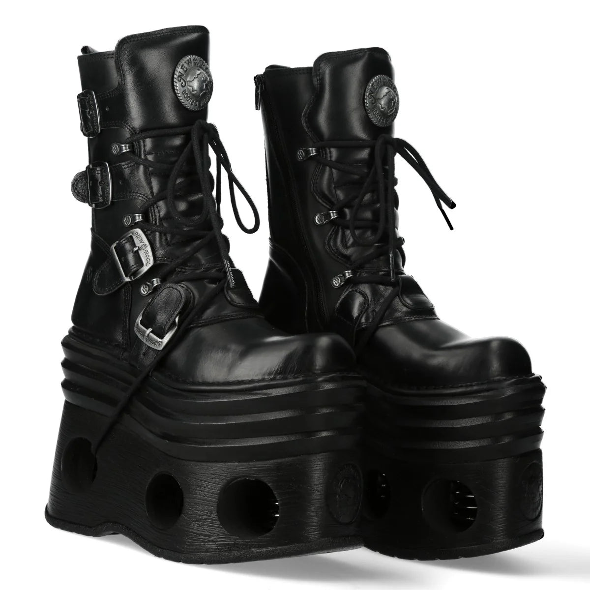 Pair of black platform boots with buckles on a white background