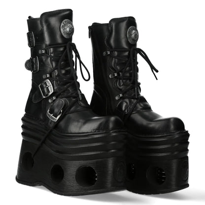 Pair of black platform boots with buckles on a white background