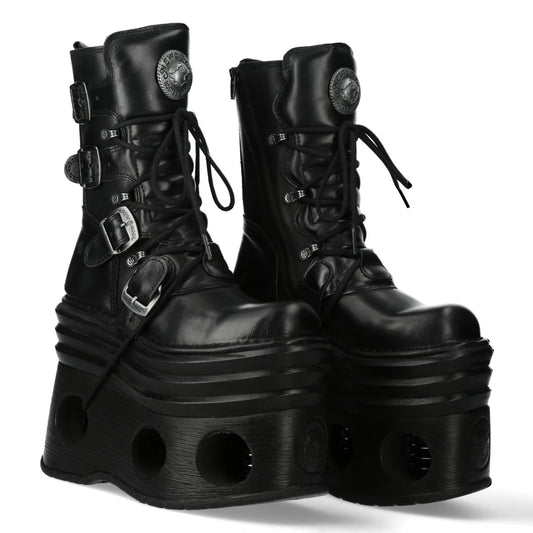 Pair of black platform boots with buckles on a white background