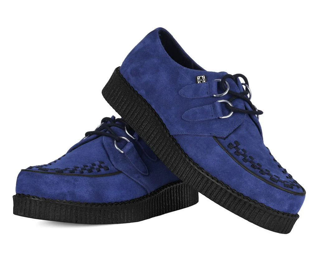 Pair of blue suede shoes with black soles on a white background