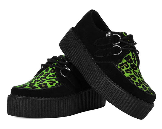 Black sneakers with green leopard print soles on a white background
