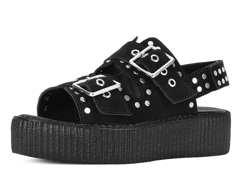 Black suede flat sandal with metallic studs and two buckle closures.
