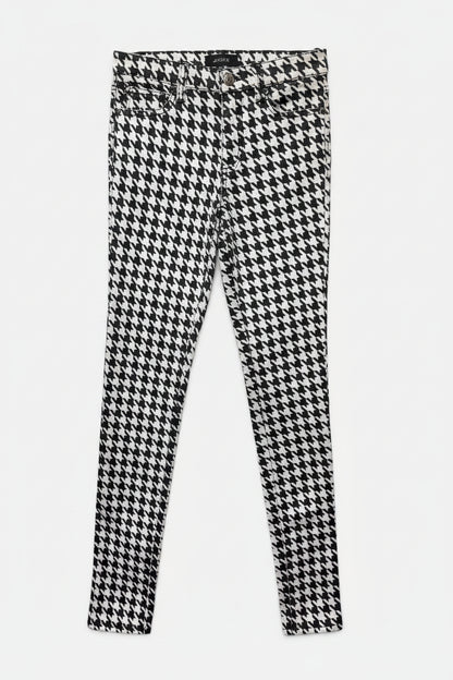 Houndstooth patterned pants on a white background