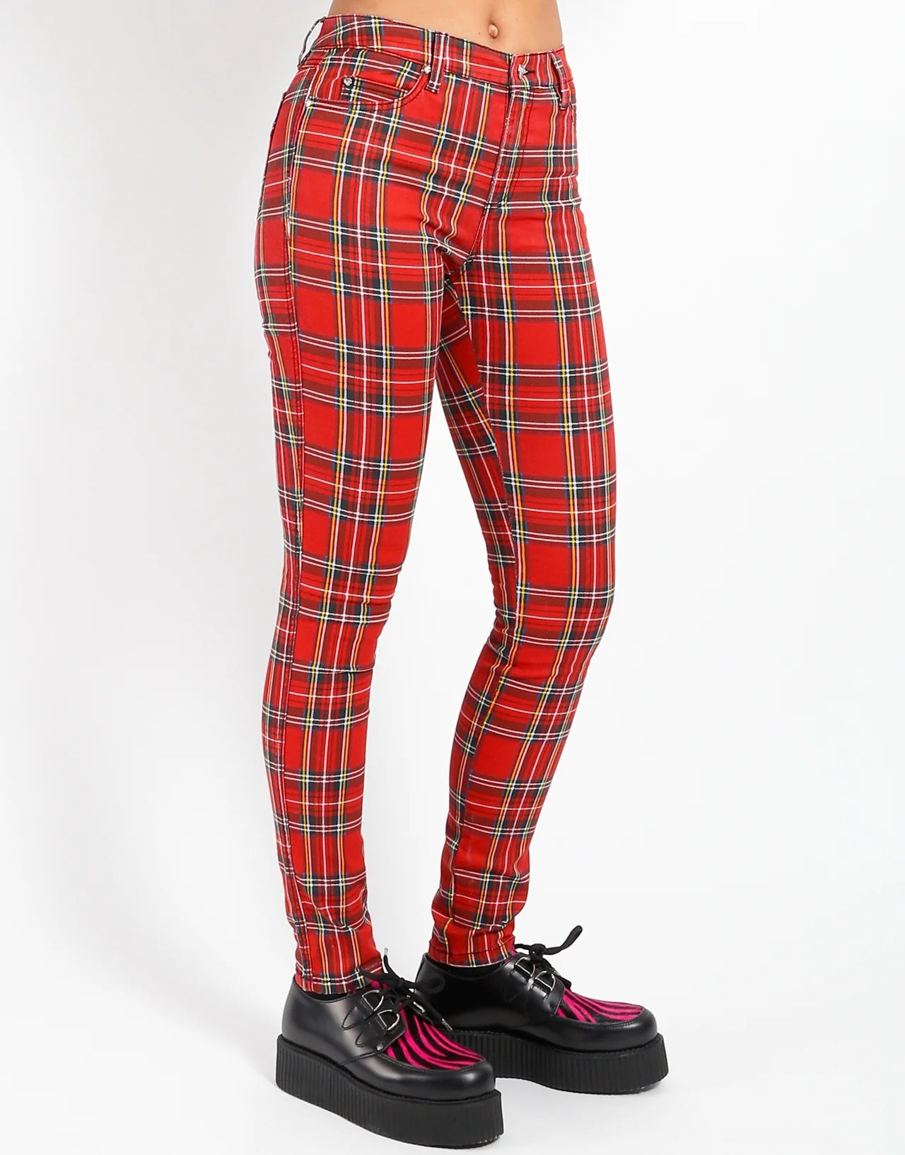 Red plaid pants worn by a person on a white background