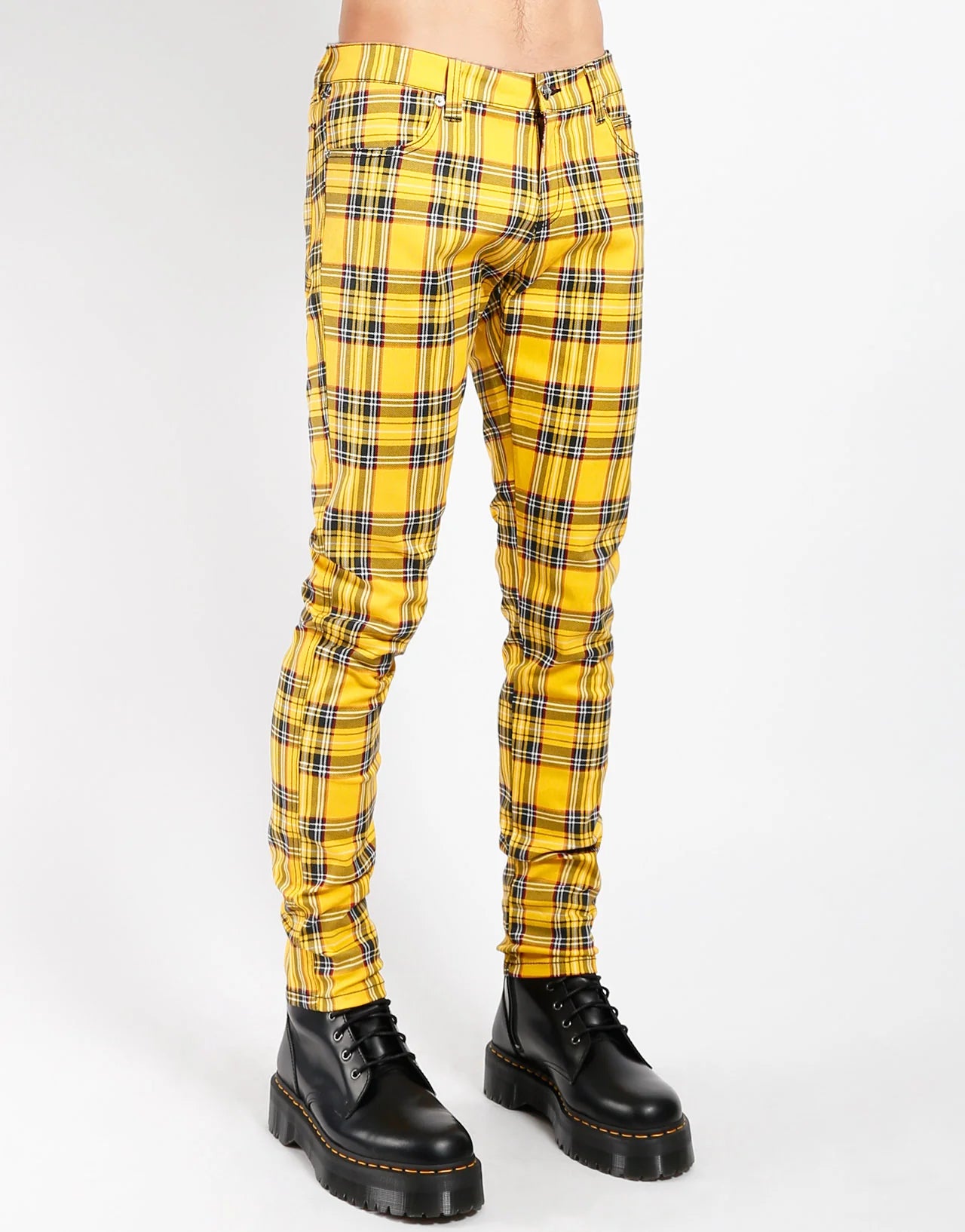 Yellow plaid pants worn by a person on a white background