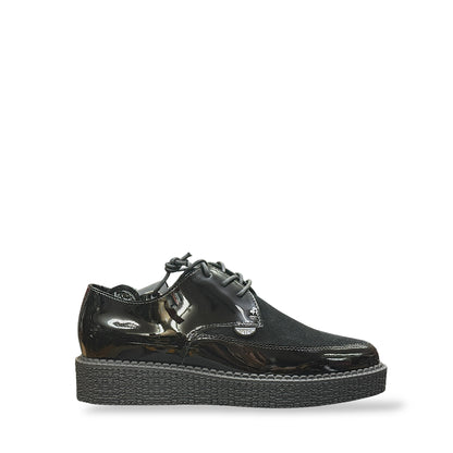 Black patent leather shoe with a thick sole on a white background
