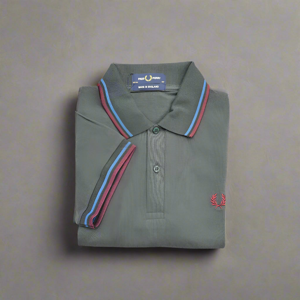 Folded gray polo shirt with colorful collar details on a white background