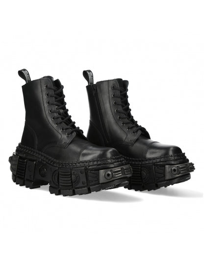 Pair of black leather boots with chunky soles on a white background